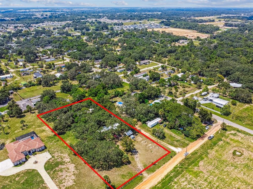 1101 Bird Road Davenport, FL 33837 - Photo 14 of 36 an aerial view of residential houses with outdoor space and trees