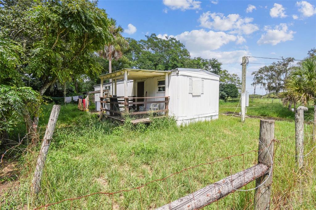 1101 Bird Road Davenport, FL 33837 - Photo 31 of 36 a backyard of a house with lots of green space and fountain