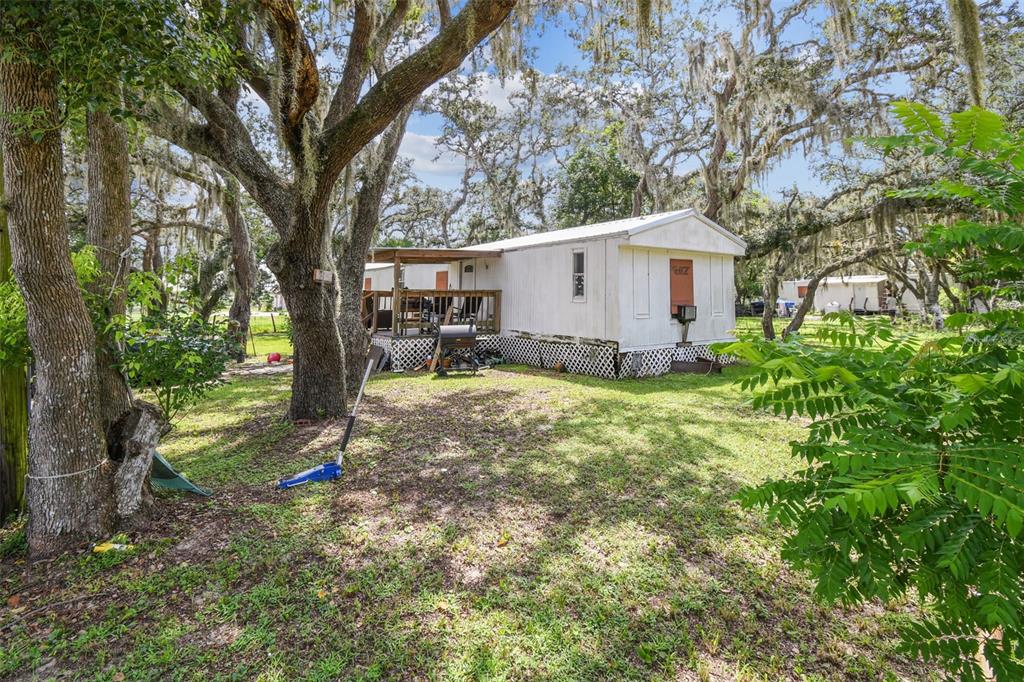 1101 Bird Road Davenport, FL 33837 - Photo 33 of 36 a white house that has a tree in front of it