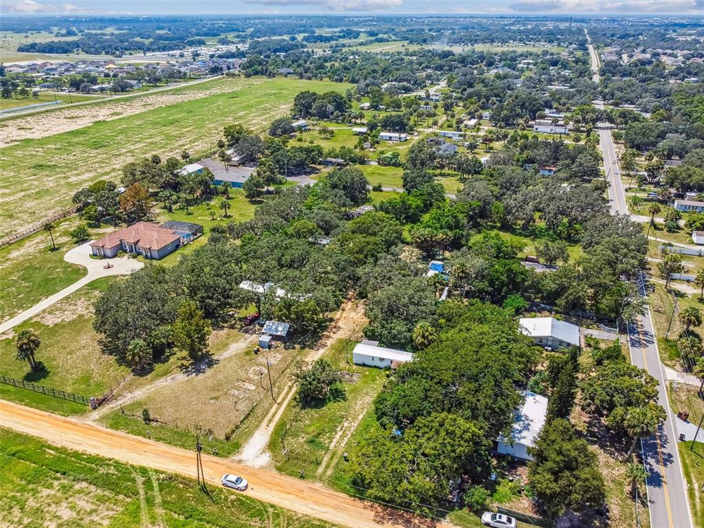 1101 Bird Road Davenport, FL 33837 - Photo 9 of 36 an aerial view of residential houses with outdoor space and trees