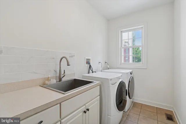 a large kitchen with kitchen island granite countertop lots of white cabinets appliances and furniture