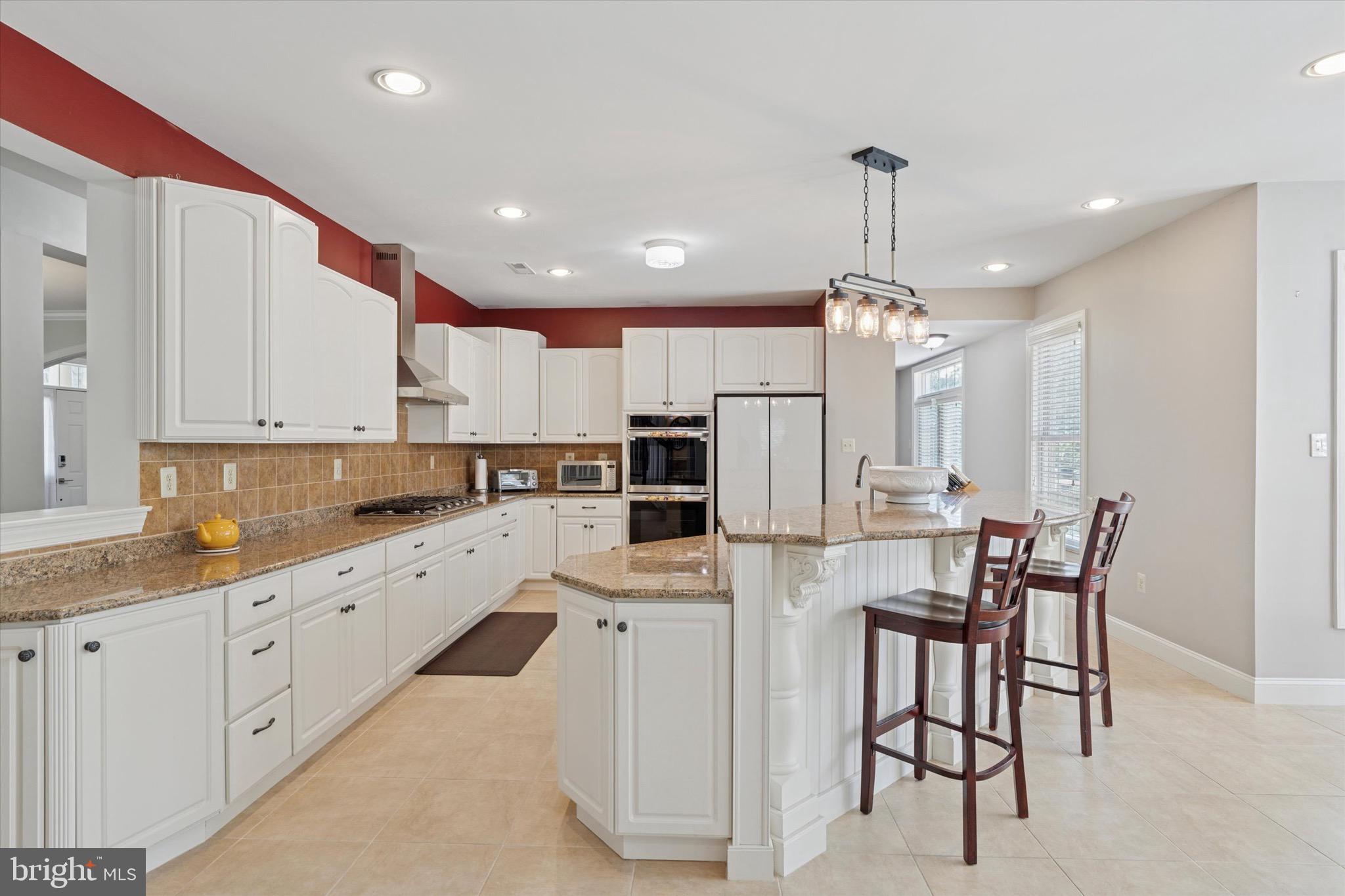 1375 Sloan Way Ambler, PA 19002 - Photo 16 of 54 a large kitchen with kitchen island granite countertop lots of white cabinets appliances and furniture