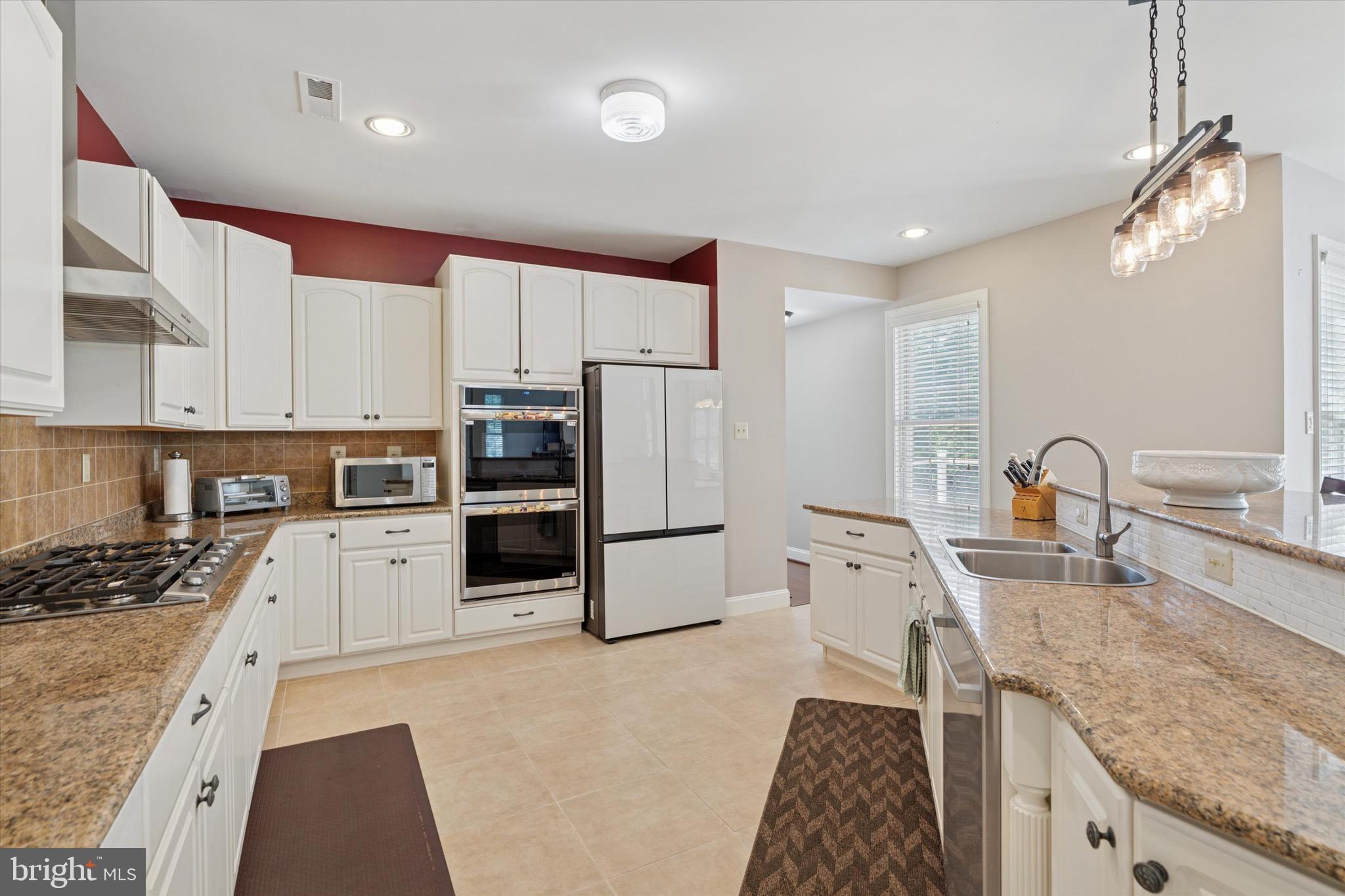 1375 Sloan Way Ambler, PA 19002 - Photo 17 of 54 a kitchen with granite countertop a refrigerator stove and sink