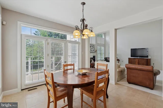 a dining room with furniture window and chandelier