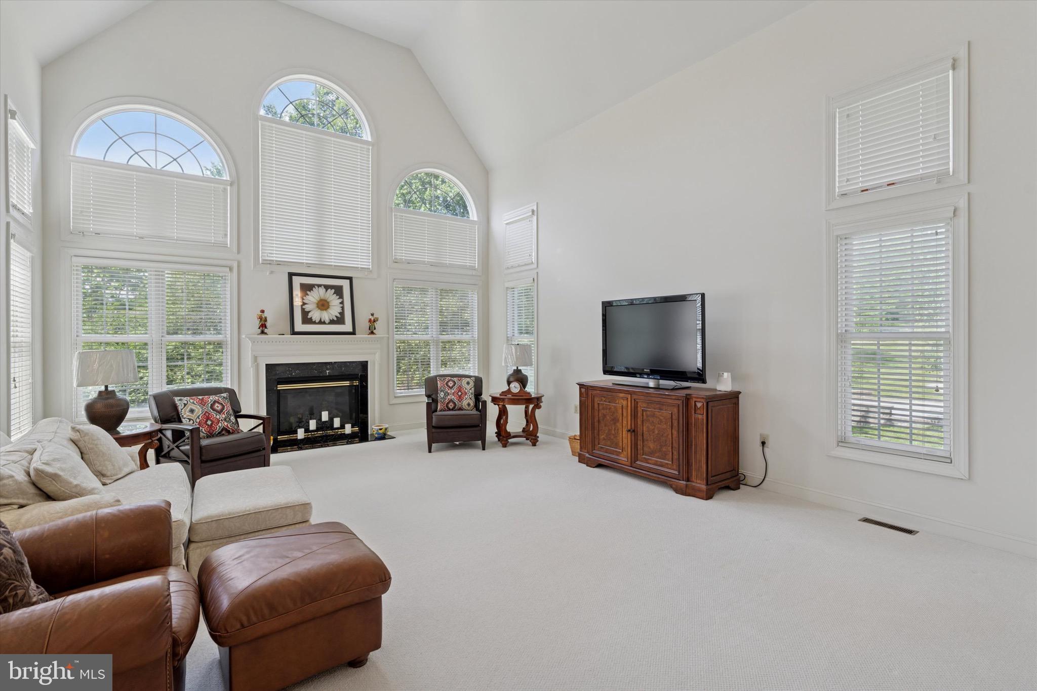 1375 Sloan Way Ambler, PA 19002 - Photo 22 of 54 a living room with furniture a flat screen tv and a fireplace