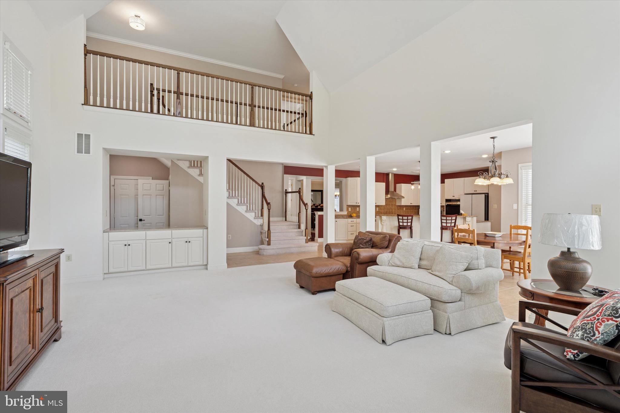 1375 Sloan Way Ambler, PA 19002 - Photo 24 of 54 a living room with furniture a flat screen tv and a floor to ceiling window