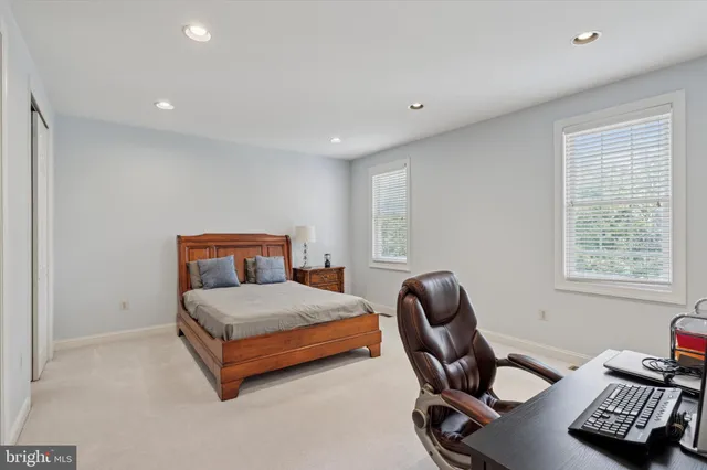 a bedroom with a bed furniture and a book shelf