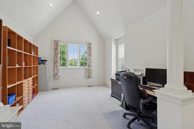 a view of a hallway to a livingroom with furniture
