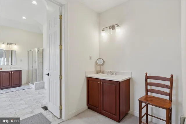 a spacious bathroom with a tub sink and mirror