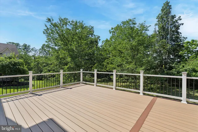 a view of a house with a big yard and large trees