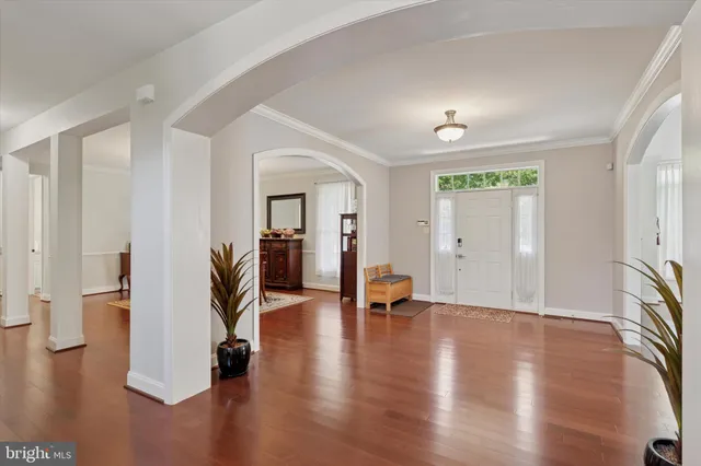 a view of entryway and hall with wooden floor
