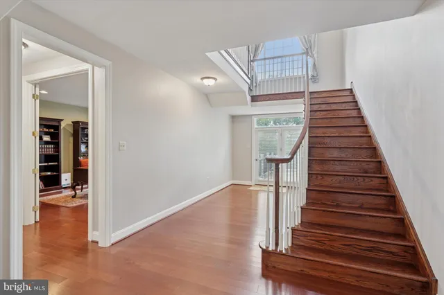 a view of an entryway with wooden floor