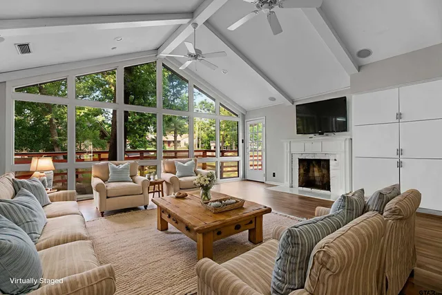 a view of empty room with wooden floor and fireplace