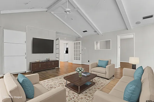 a view of an empty room with wooden floor