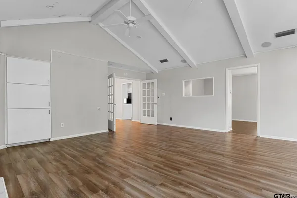 a bedroom with a bed tv and a chandelier