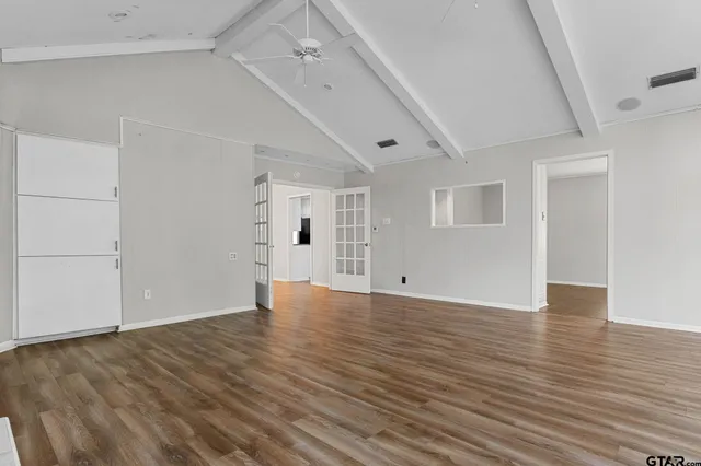 a bedroom with a bed tv and a chandelier