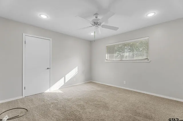 a bathroom with a granite countertop sink toilet and mirror