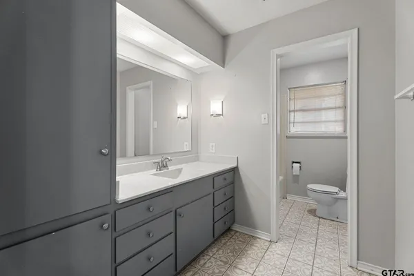 a bathroom with a bathtub and a window