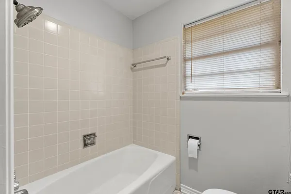 a bedroom with a bed and a potted plant