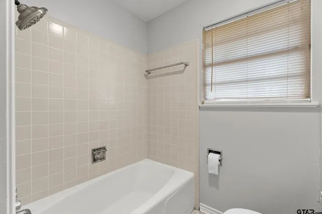 a bedroom with a bed and a potted plant