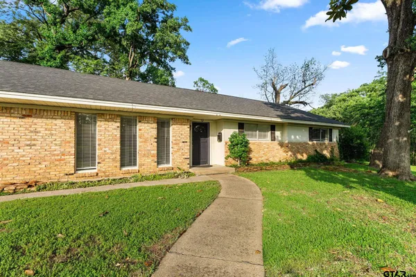 a front view of a house with a yard table and chairs