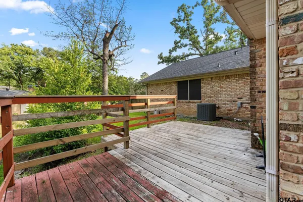a view of a house with a yard and hanging chair