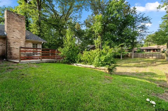 a view of a house with a yard and sitting area