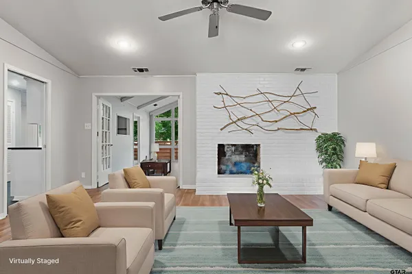 a living room with furniture and a fireplace