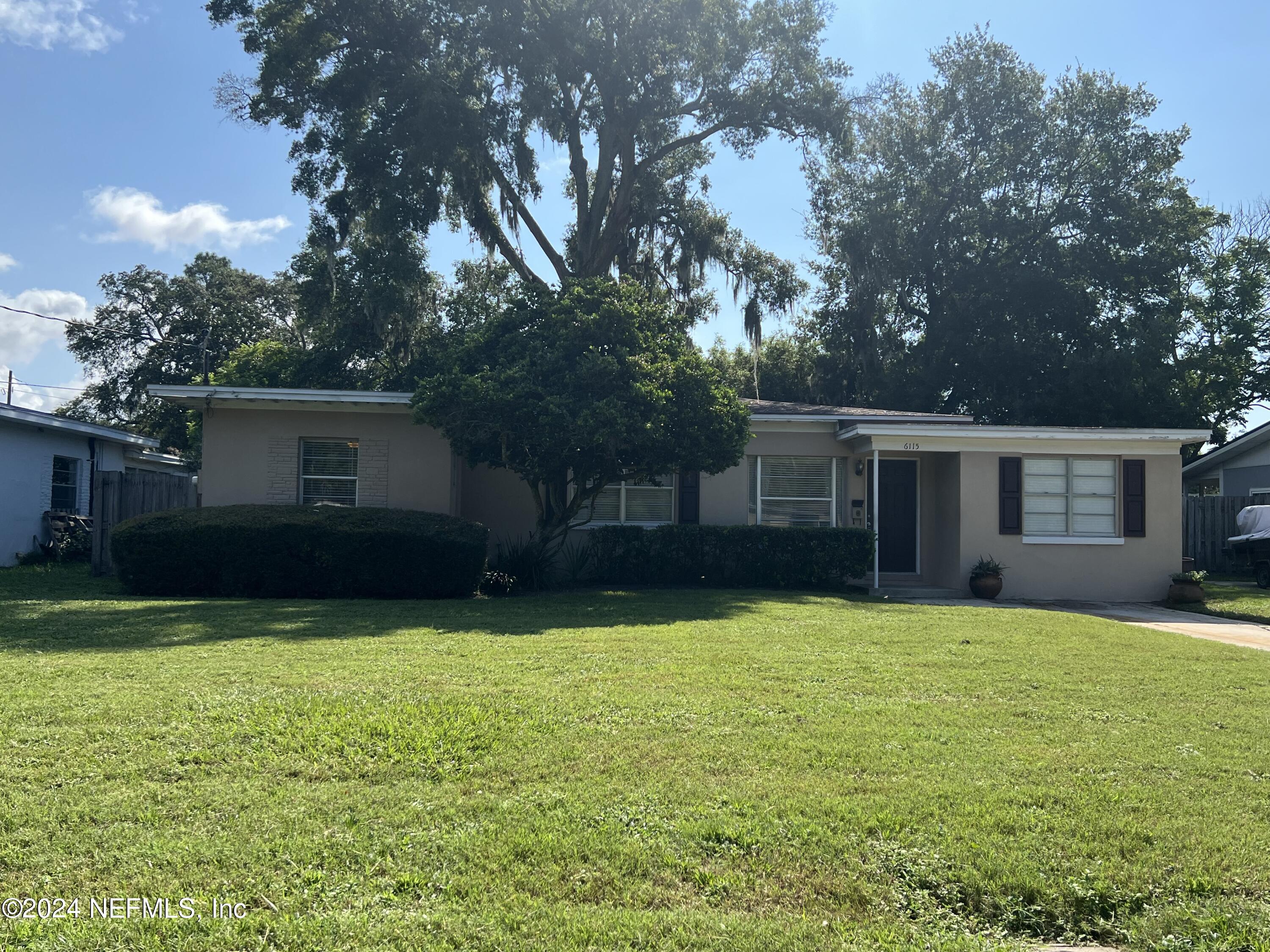 6115 Stetson Road Jacksonville, FL 32217 - Photo 1 of 25 a view of a house with a yard and trees