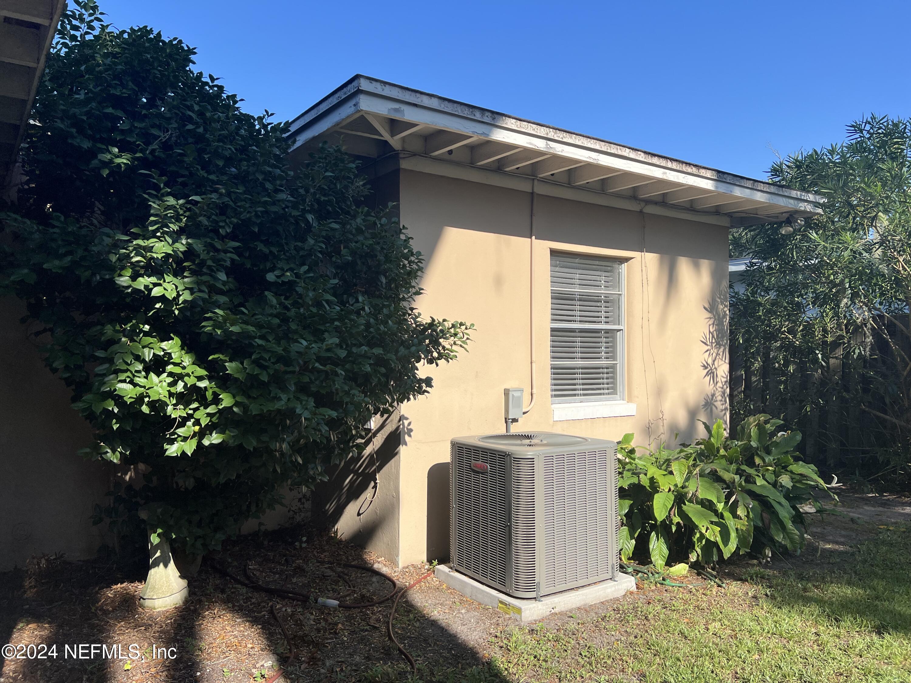 6115 Stetson Road Jacksonville, FL 32217 - Photo 11 of 25 a yellow house with flower garden in front of it
