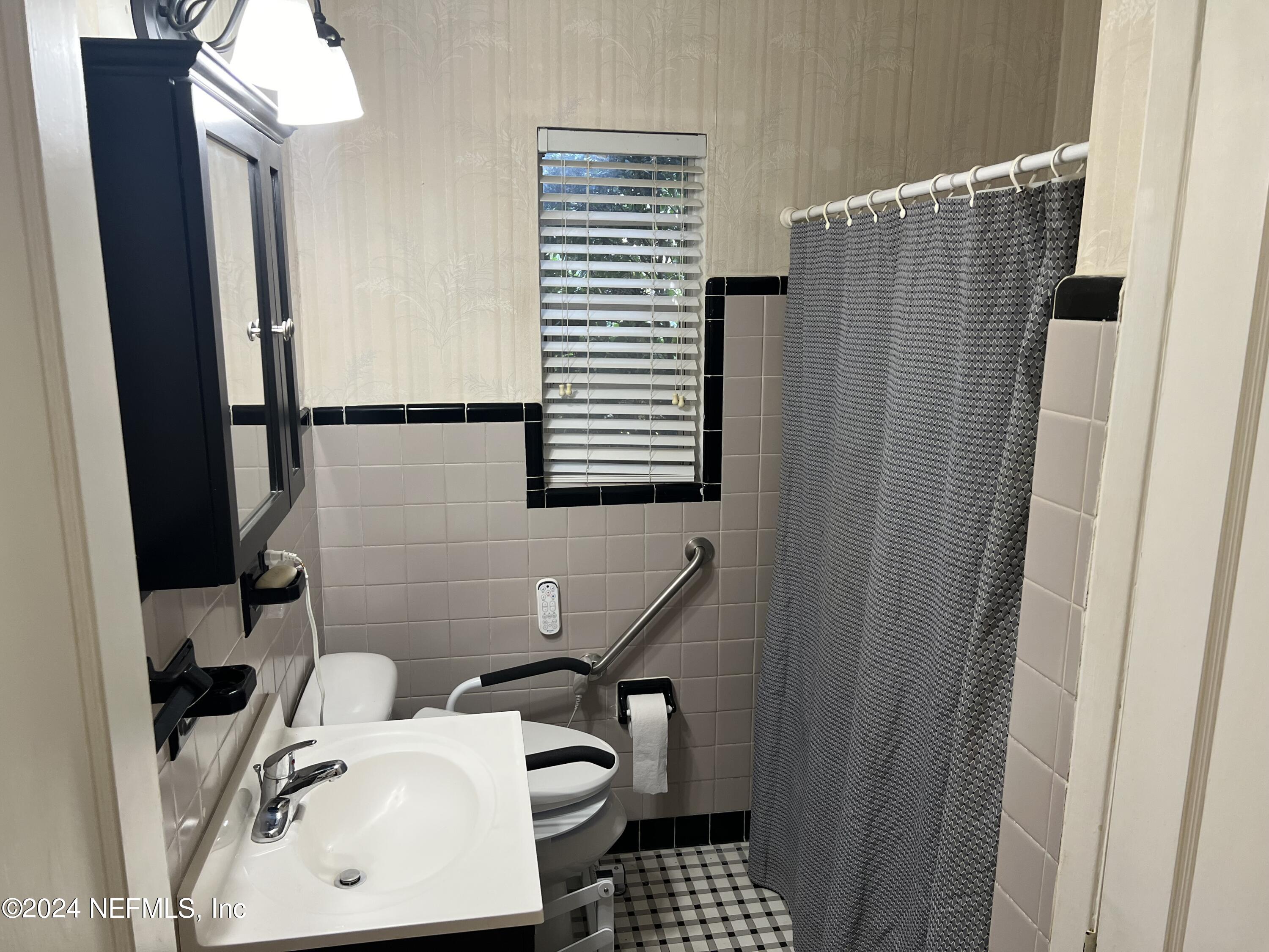 6115 Stetson Road Jacksonville, FL 32217 - Photo 6 of 25 a bathroom with a sink and a mirror