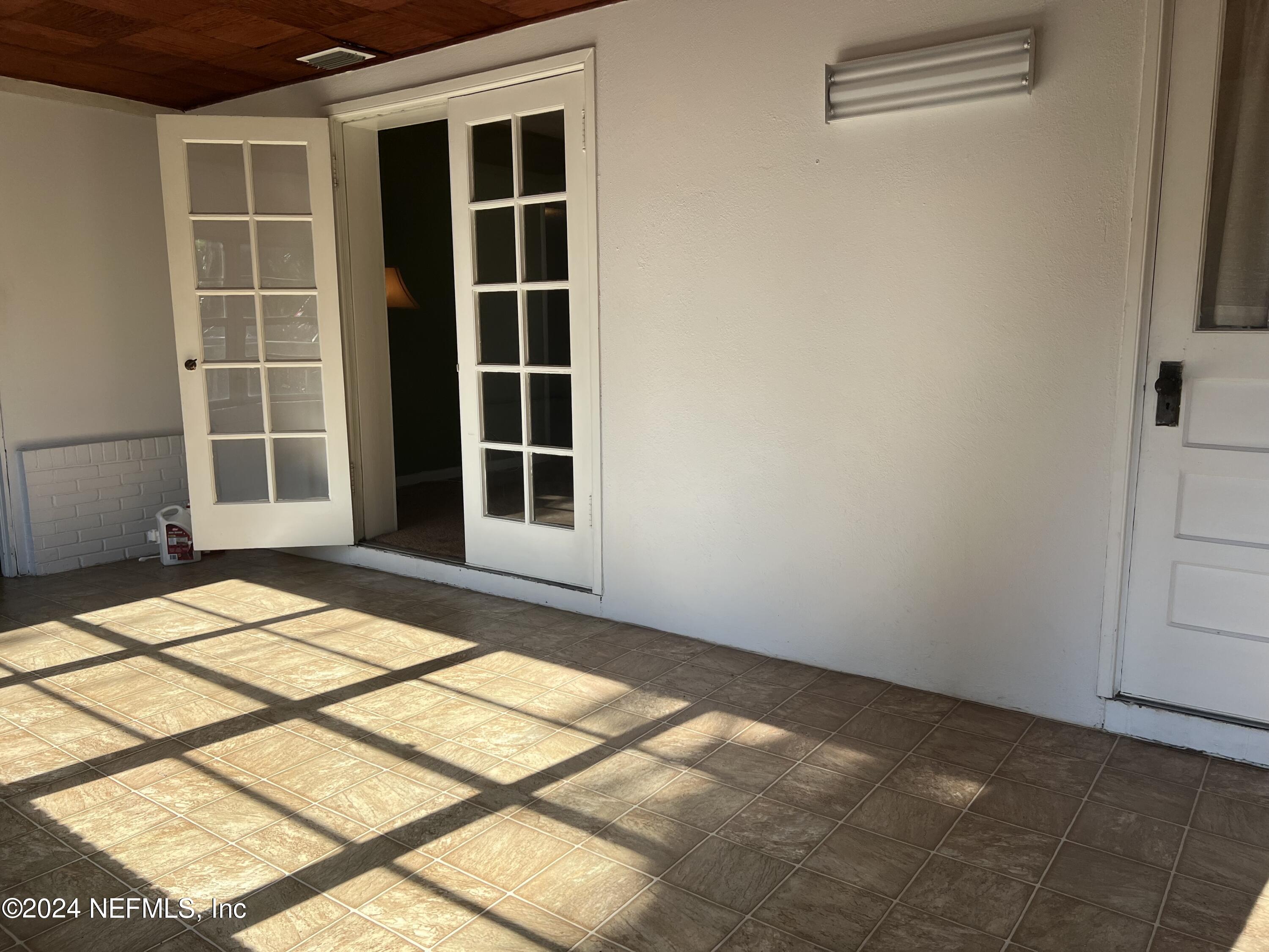 6115 Stetson Road Jacksonville, FL 32217 - Photo 10 of 25 a view of empty room with windows