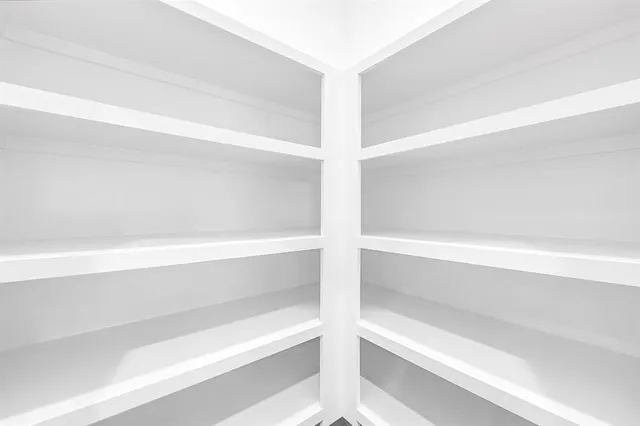 a view of kitchen with refrigerator and wooden floor