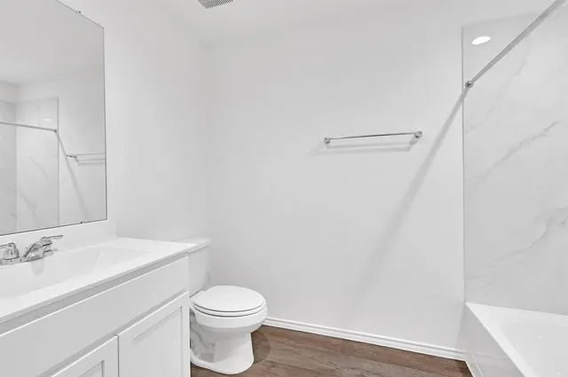 a bathroom with a sink a toilet and vanity