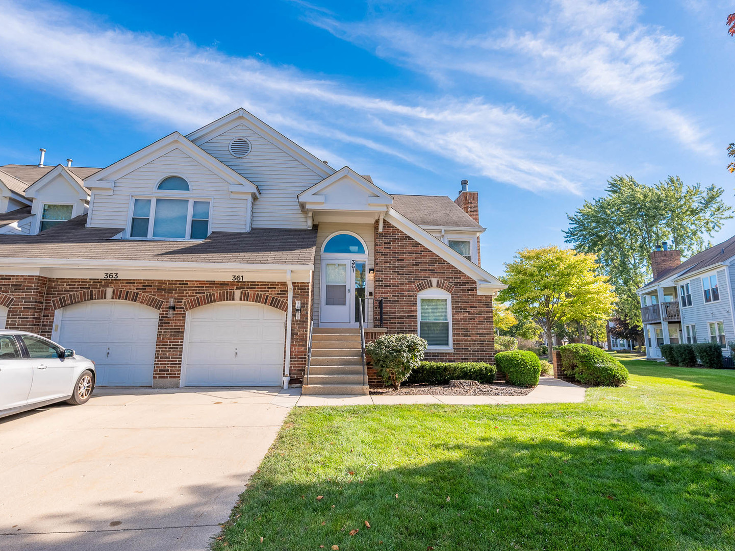 a front view of house with yard and green space
