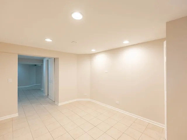 an empty room with white walls and tiles
