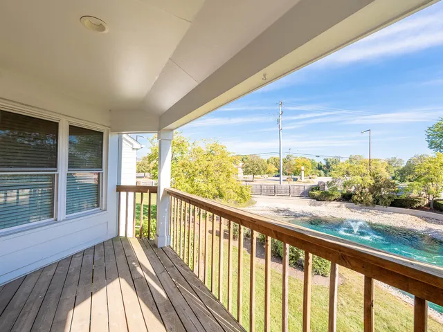 a view of a balcony with wooden floor