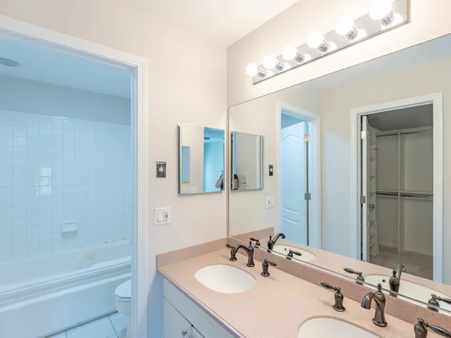 a bathroom with a tub sink and mirror