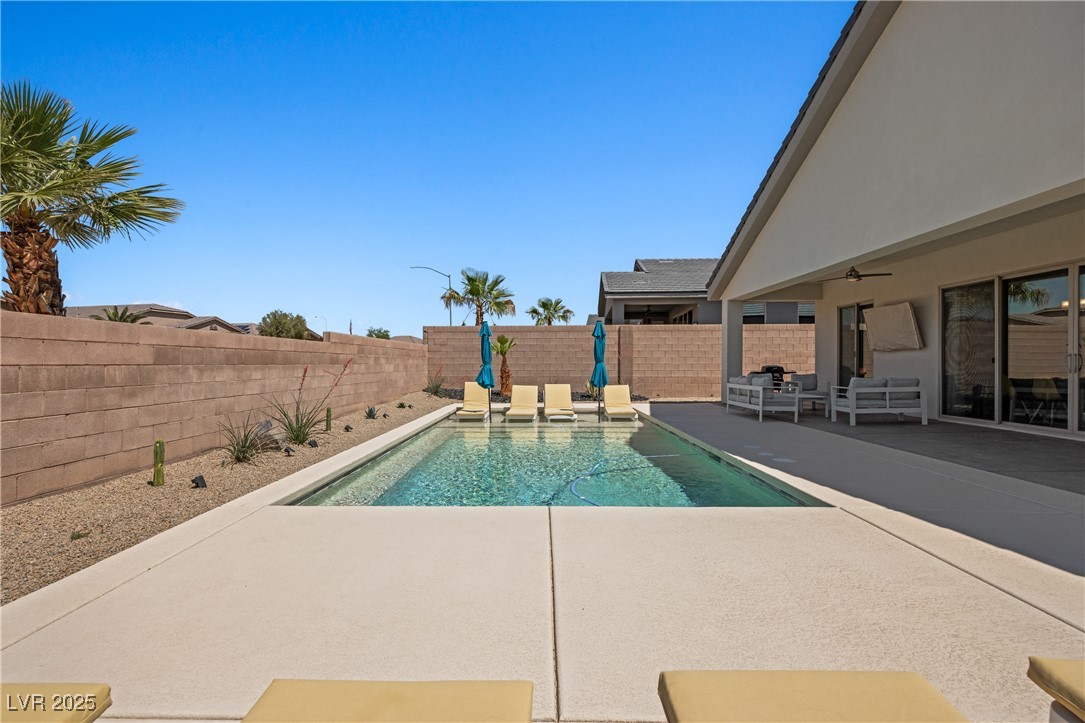 1357 Manassas Ridge Mesquite, NV 89027 - Photo 55 of 72 View of pool with a patio area, a fenced backyard, and an outdoor living space