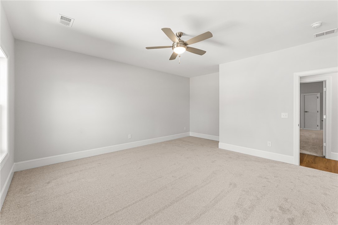 141 Rickys Path Easley, SC 29642 - Photo 35 of 40 This spacious bedroom offers ample natural light and a serene ambiance.
