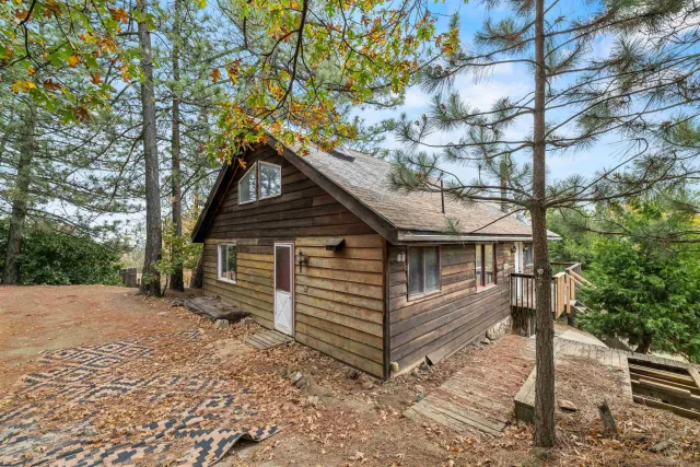 a backyard of a house with barbeque oven and outdoor seating