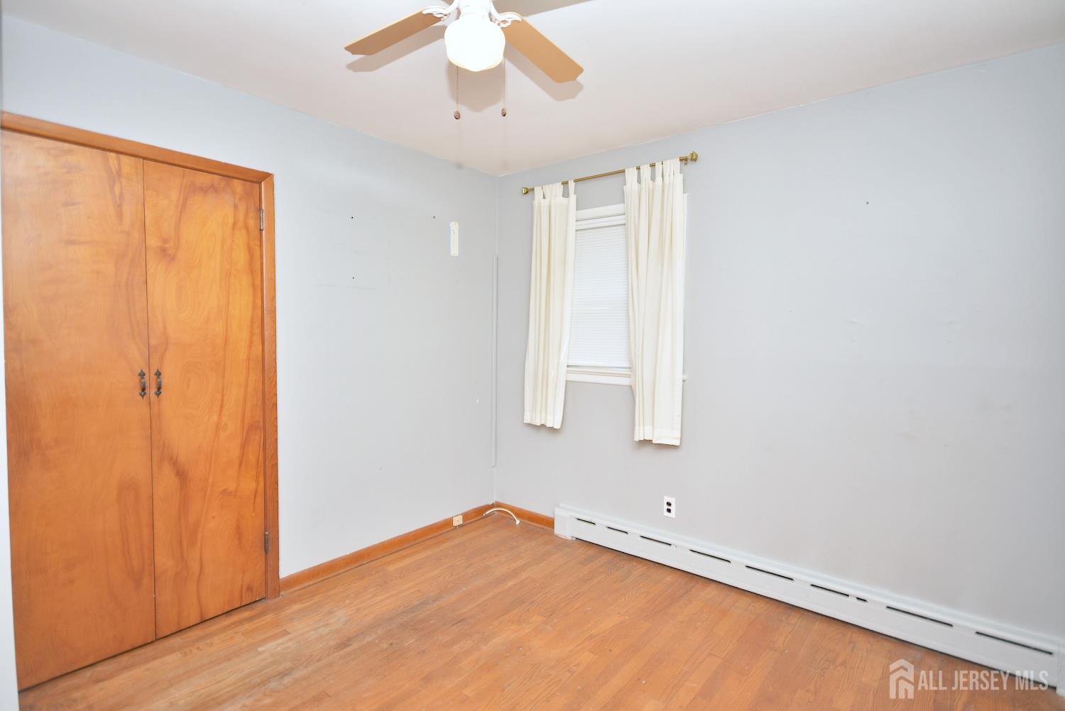 9 Emma Place Middlesex, NJ 08846 - Photo 15 of 32 wooden floor in an empty room with a window