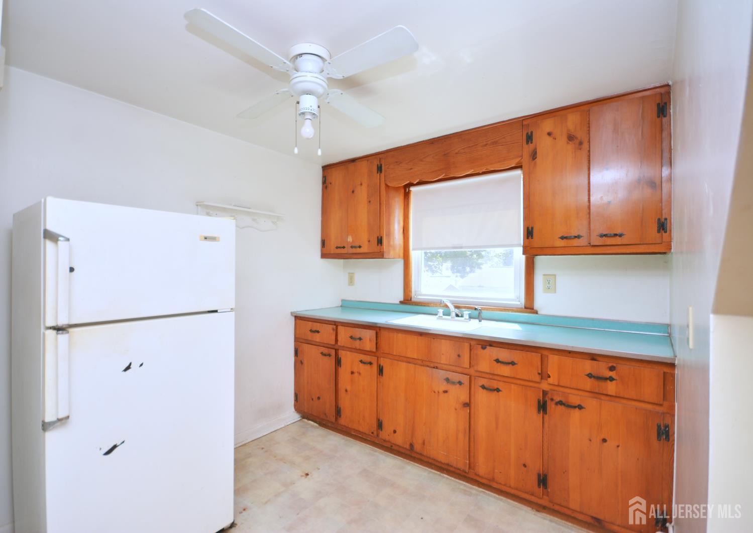 9 Emma Place Middlesex, NJ 08846 - Photo 24 of 32 a kitchen with white cabinets and white appliances