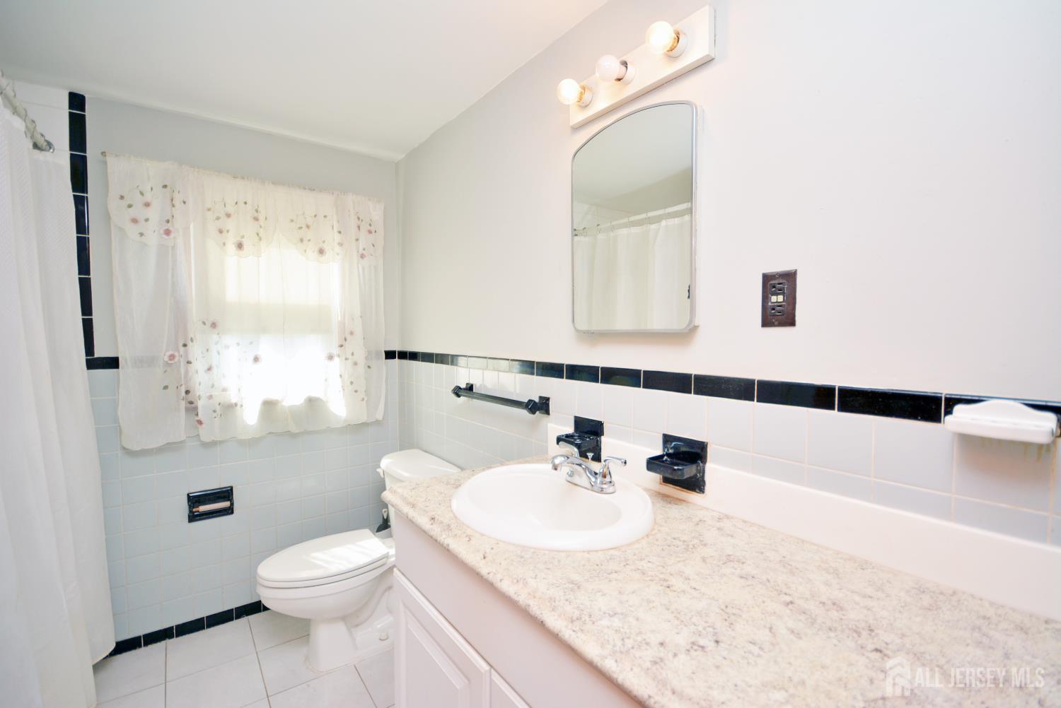 9 Emma Place Middlesex, NJ 08846 - Photo 27 of 32 a bathroom with a granite countertop sink a mirror and a toilet
