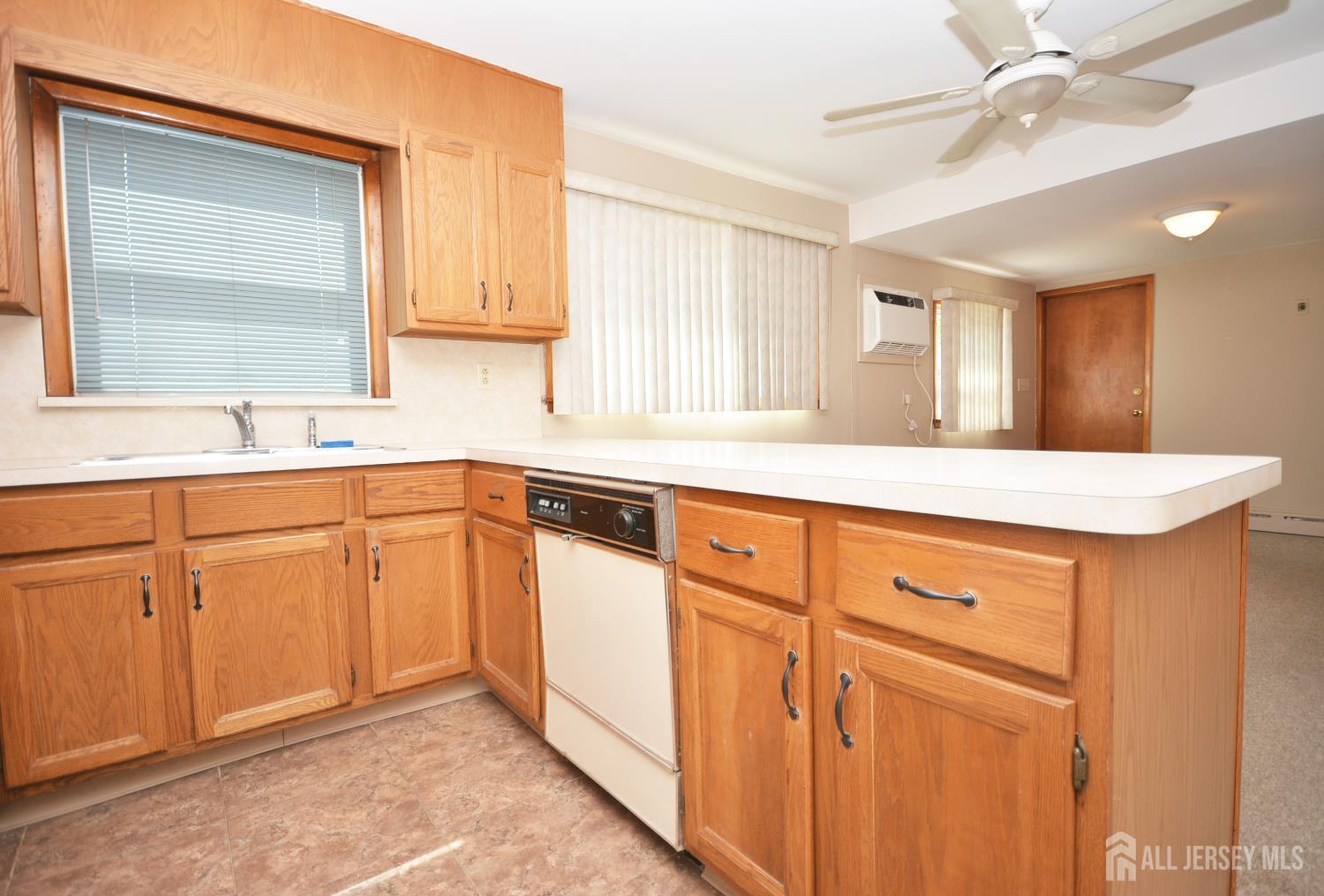 9 Emma Place Middlesex, NJ 08846 - Photo 6 of 32 a kitchen with granite countertop white cabinets and white appliances