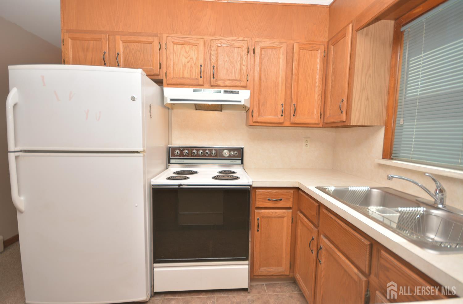 9 Emma Place Middlesex, NJ 08846 - Photo 7 of 32 a kitchen with a sink a stove and a refrigerator
