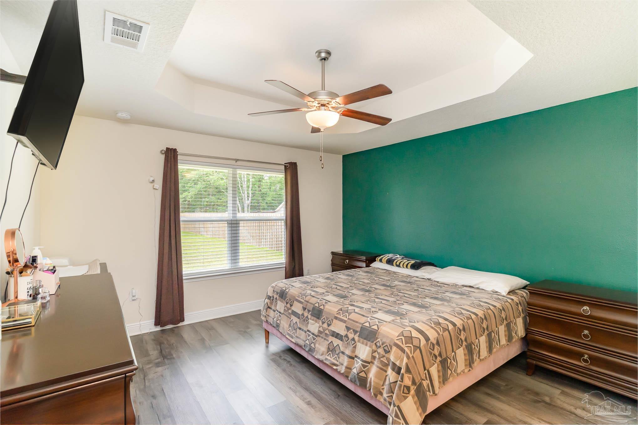 3315 Doyle Hawkins Road Navarre, FL 32566 - Photo 12 of 33 a bedroom with a bed and a window