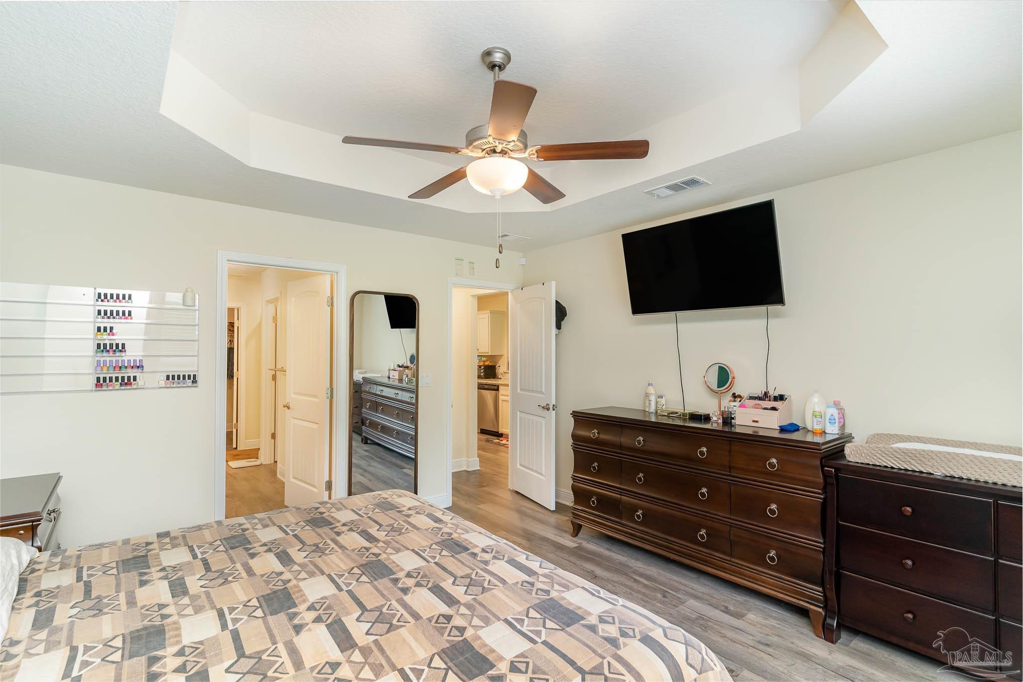 3315 Doyle Hawkins Road Navarre, FL 32566 - Photo 14 of 33 a bedroom with a bed and a flat screen tv