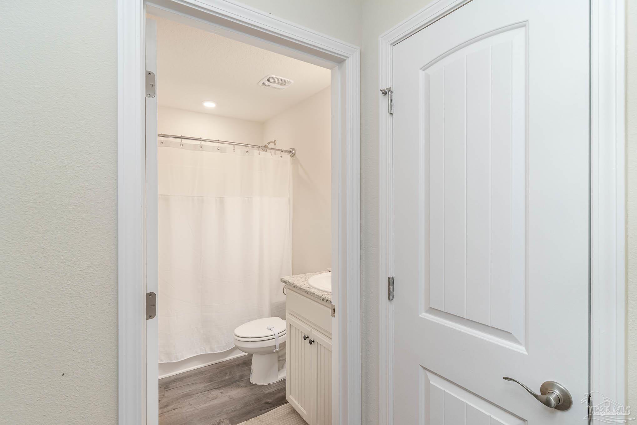 3315 Doyle Hawkins Road Navarre, FL 32566 - Photo 18 of 33 a bathroom with a toilet a sink and a shower