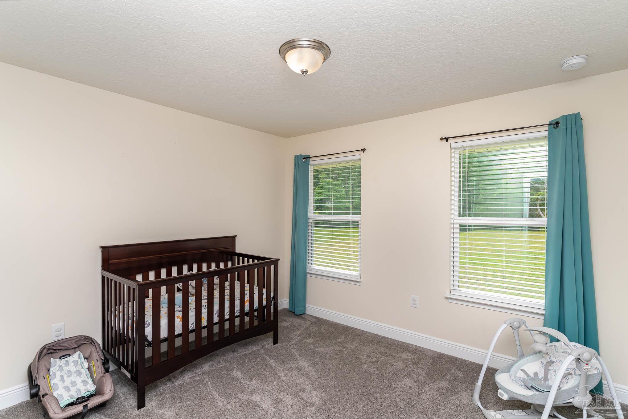 3315 Doyle Hawkins Road Navarre, FL 32566 - Photo 21 of 33 a bedroom with a window and a bed